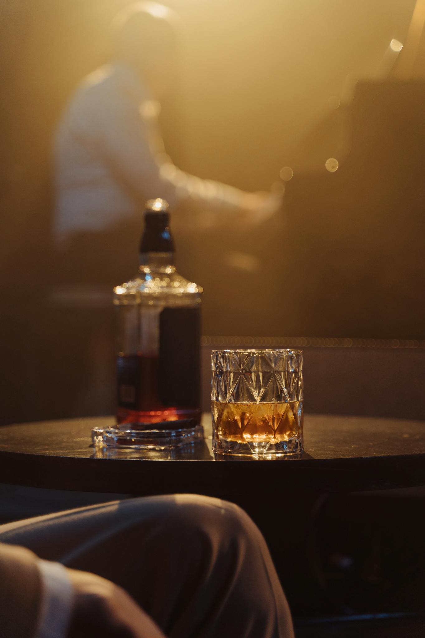A cozy lounge scene with whiskey glass and blurred pianist, perfect for nightlife or bar themes.