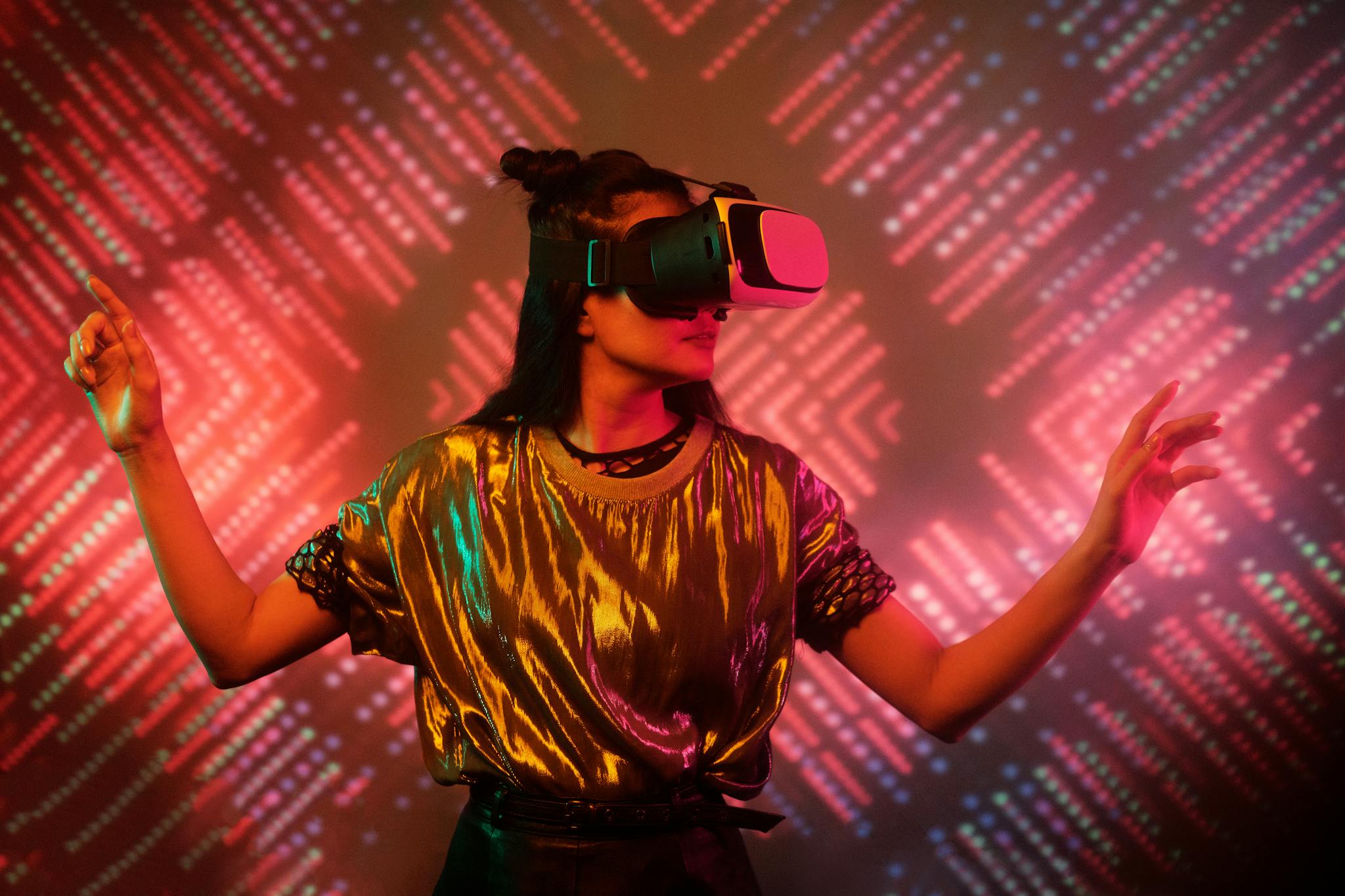 Woman experiencing virtual reality with a vibrant, colorful background, fully immersed in a futuristic digital environment.